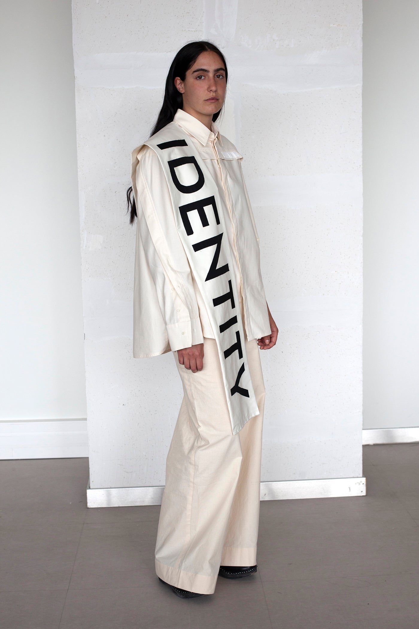 The White Canvas scarf in natural cotton color made from leftover deadstock fabrics and with black patched IDENTITY letters. Unique piece, made in France