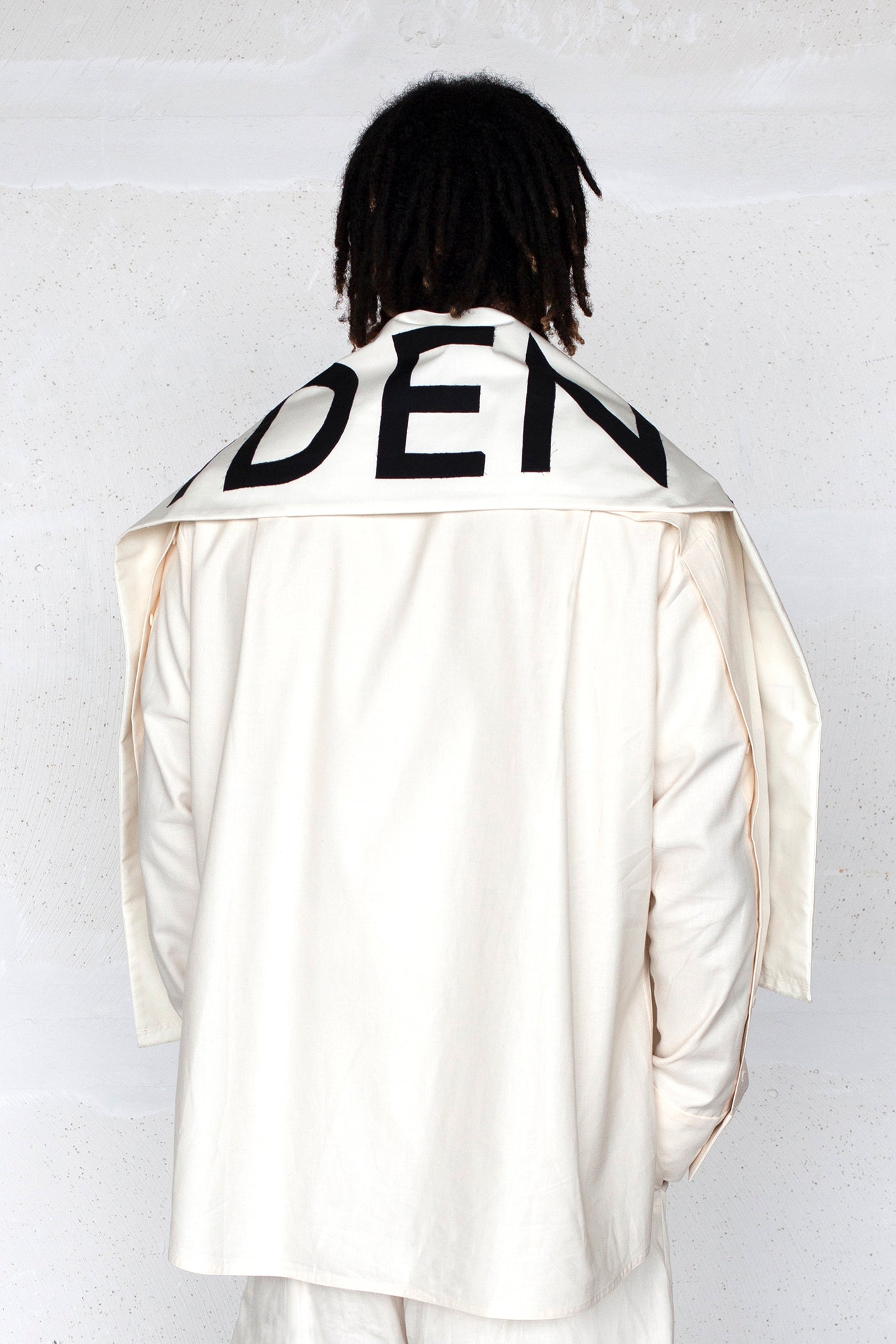 The White Canvas scarf in natural cotton color made from leftover deadstock fabrics and with black patched IDENTITY letters. Unique piece, made in France