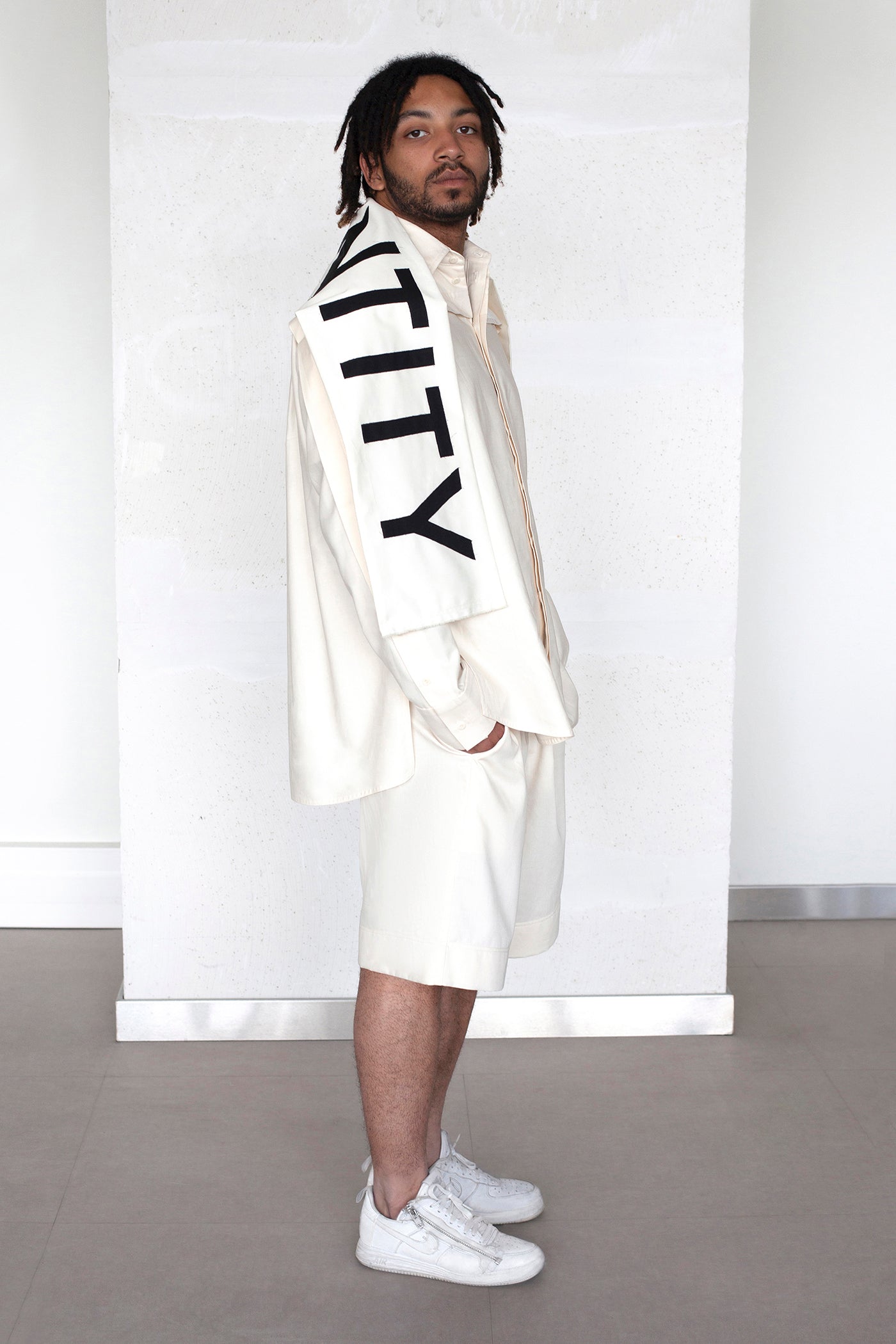The White Canvas scarf in natural cotton color made from leftover deadstock fabrics and with black patched IDENTITY letters. Unique piece, made in France