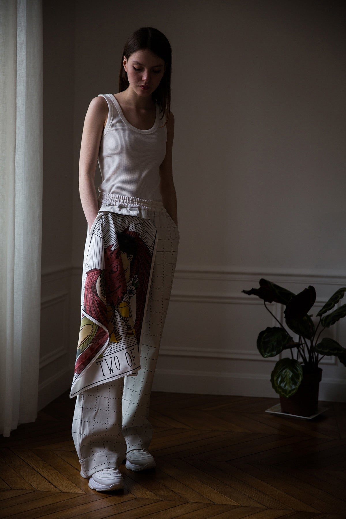 Dalva is wearing White Canvas sustainable light grey color, genderless, seasonless casual checks trousers, size S. The Essential checks trousers have minimal modern aesthetics design allowing comfort and bringing self-confidence. This unique piece is made locally in Paris to reduce environmental impact and guarantee high quality and durability of the products.