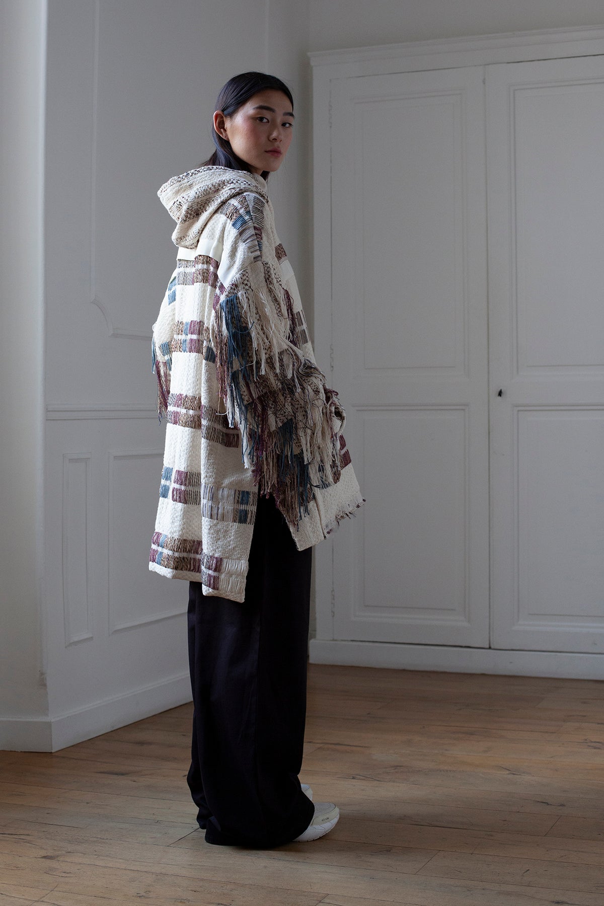 The artisanal fringe hoody is a mix of tweed fabrics from luxury houses deadstock. This unique piece is made locally in Paris to reduce environmental impact and guarantee high quality and durability of the products. It is gender neutral, has oversize fit and has a minimal impact on environment.