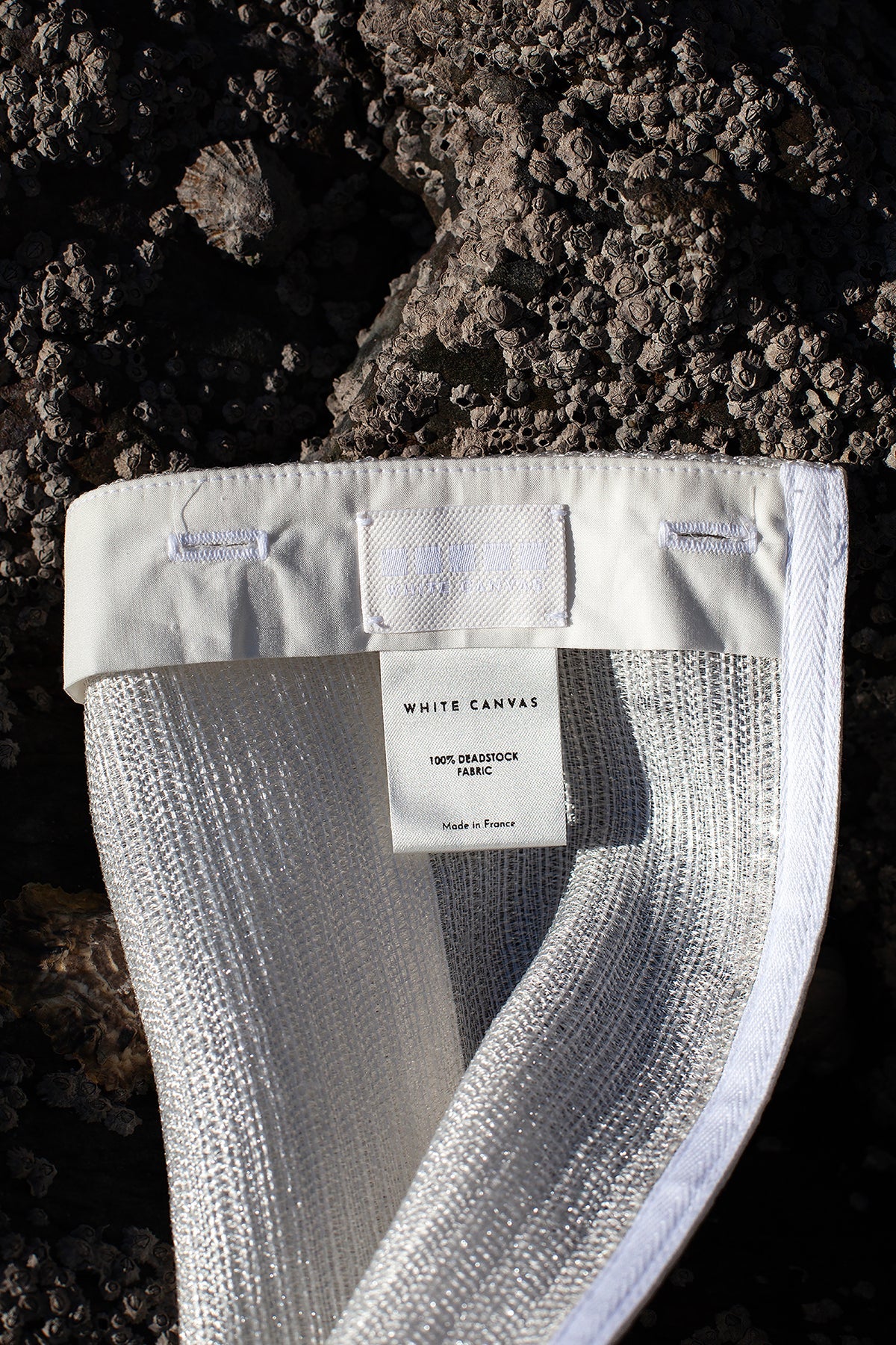 The silver fringes panel is an exclusive unique sustainable piece made in France. It is made to be attached to the essential pieces to personalize them and wear them your unique way.