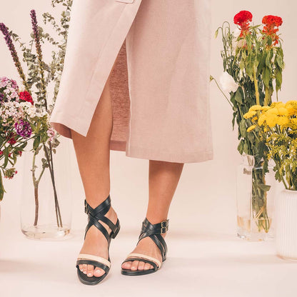 Women wearing flat open sandals with a summer beige dress made with sustainable materials | NAE